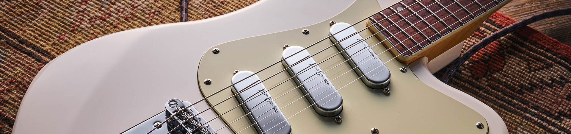 A close up of a classic white guitar