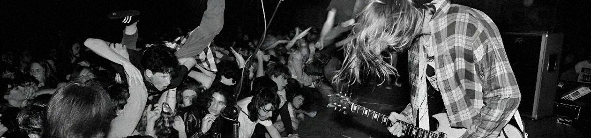 A black and white picture of a high energy Grunge gig in a small venue back in the day
